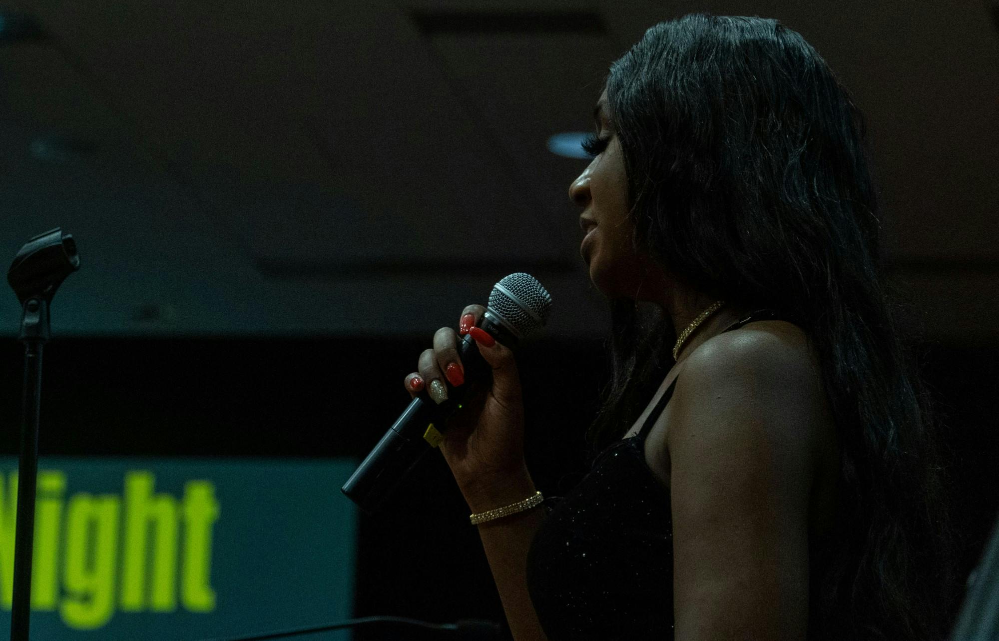 SAVVY member Aleceya Edwards delivers spoken word to gala attendees during the talent showcase on Feb. 25, 2022. Edwards performed two of her own poems following years of working backstage at the gala.