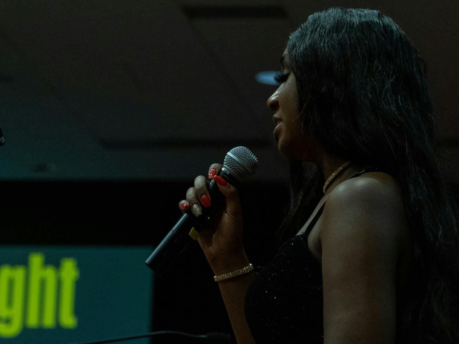 SAVVY member Aleceya Edwards delivers spoken word to gala attendees during the talent showcase on Feb. 25, 2022. Edwards performed two of her own poems following years of working backstage at the gala.