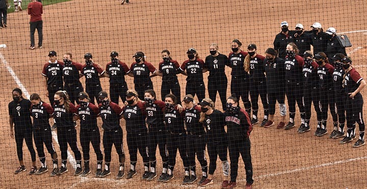 The South Carolina softball team stands together after its loss to Arkansas on March 13, 2021.