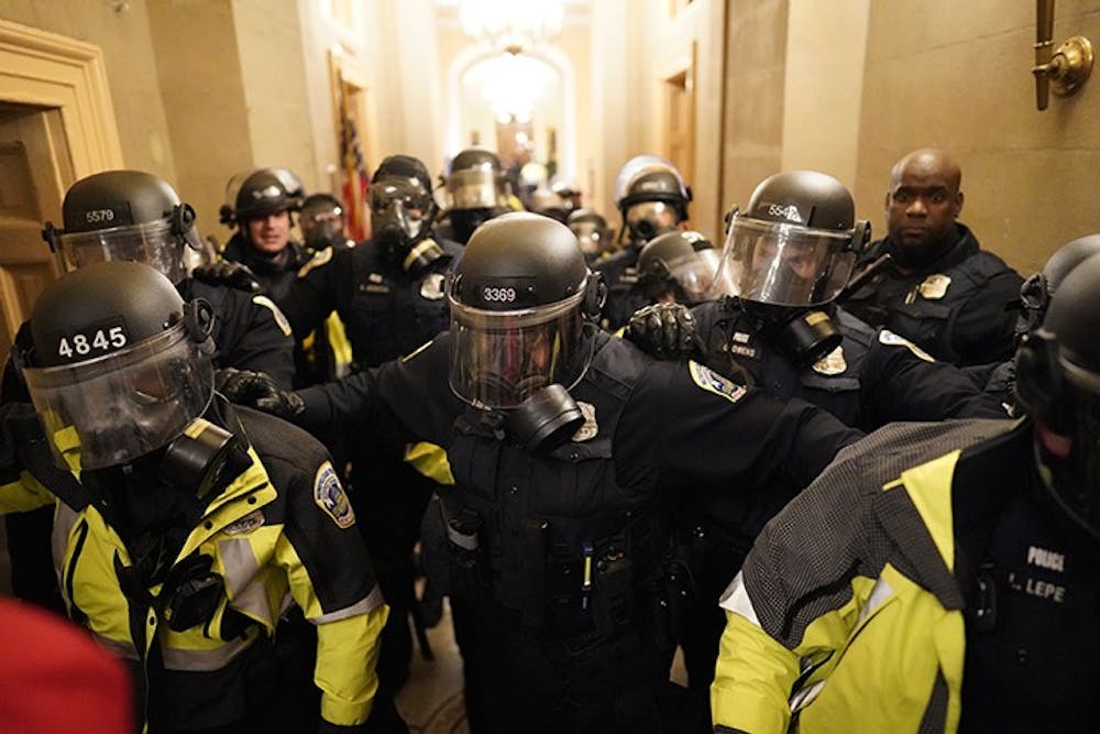 Riot police enter the hallway inside the Capitol building on Jan. 6, 2021.