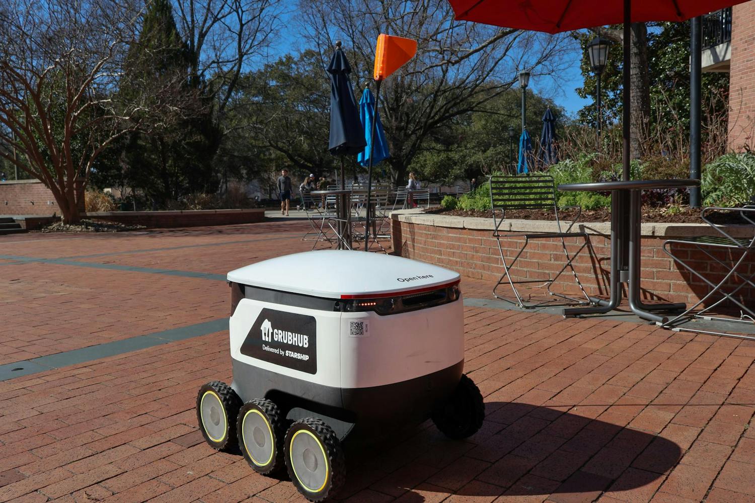 A Grubhub robot crosses through the Russell House patio on Feb. 6, 2024. The robot delivered a Panera order to Close-Hipp.