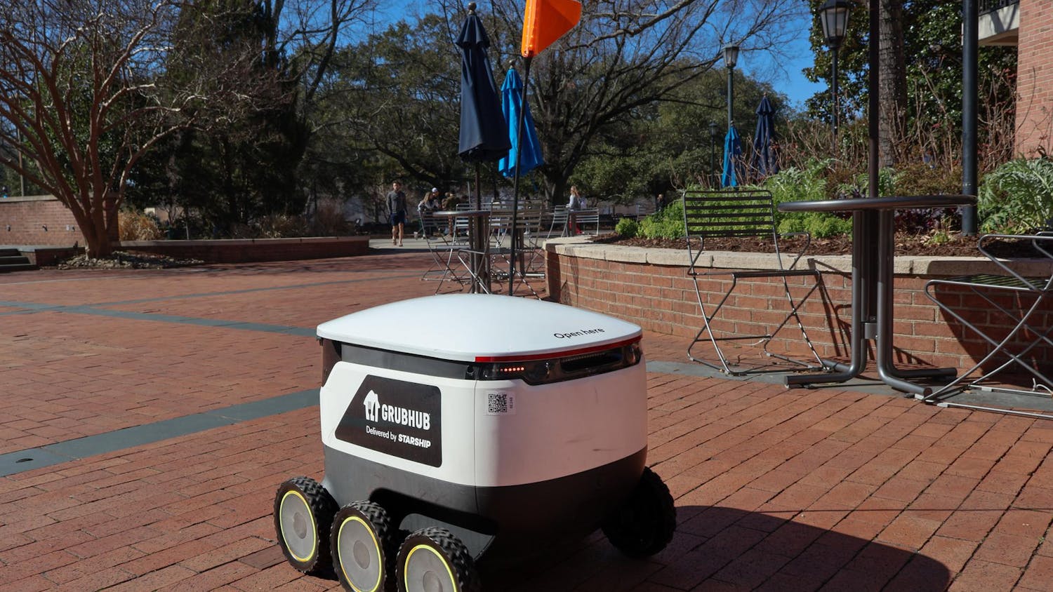 A Grubhub robot crosses through the Russell House patio on Feb. 6, 2024. The robot delivered a Panera order to Close-Hipp.
