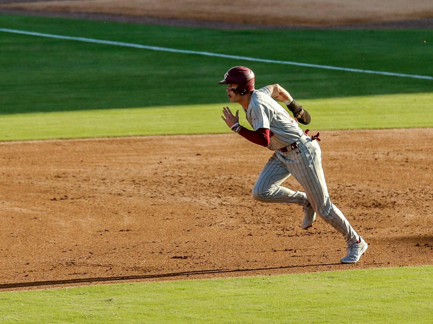 Fifth-year outfielder Dylan Brewer runs up the second baseline during the “Battle at Bull Street” game between South Carolina and Clemson at Segra Park on March 2, 2024. Brewer went 2-4 in at bats for South Carolina.