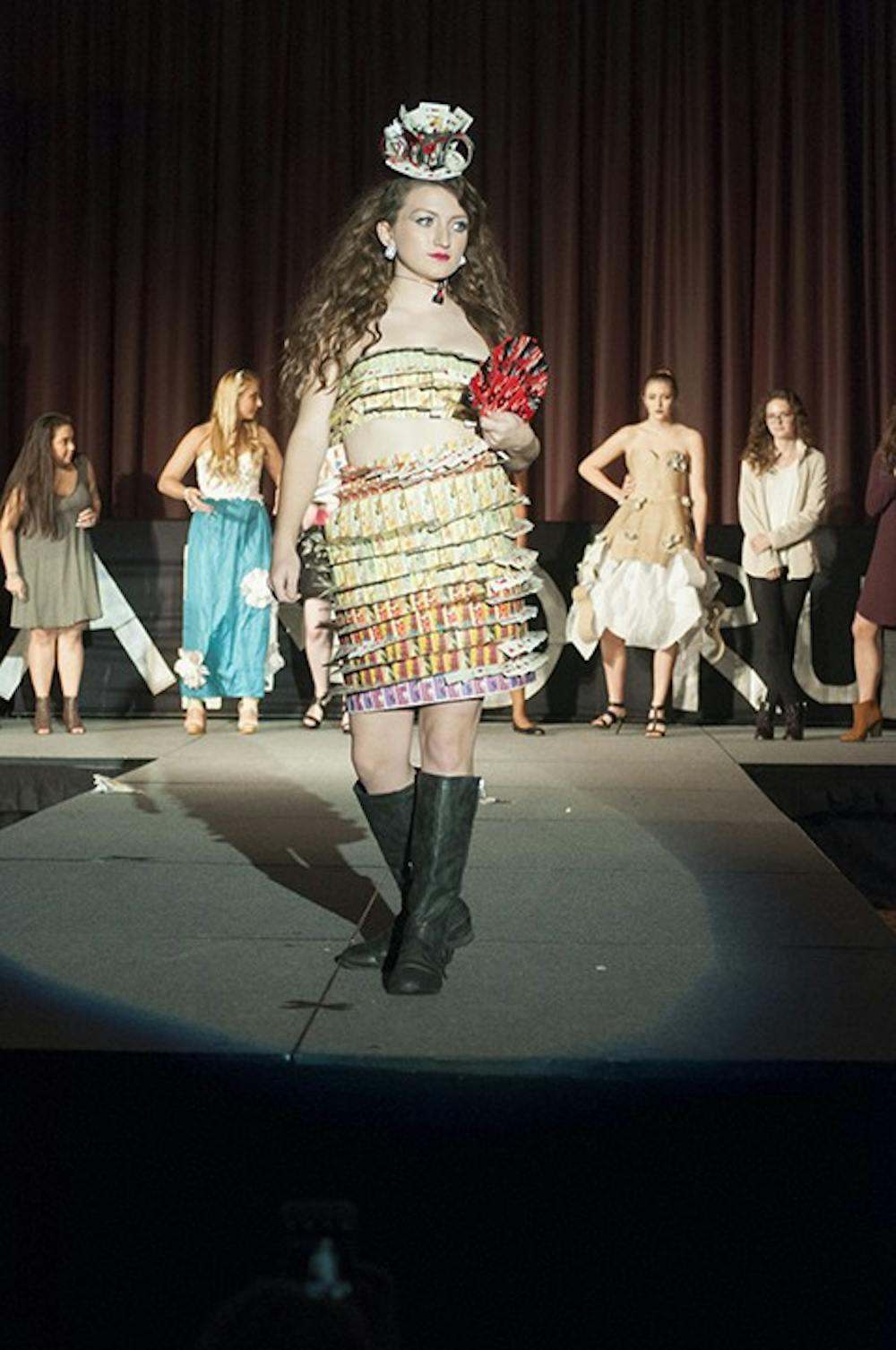 <p>Third-year retail and fashion merchandising student Anne Coleman took home first place with her design made primarily from old playing cards. Her younger sister modeled the design for her.</p>