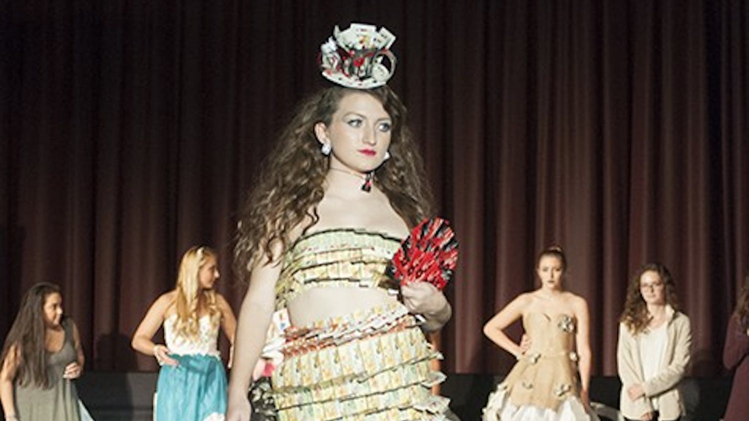 Third-year retail and fashion merchandising student Anne Coleman took home first place with her design made primarily from old playing cards. Her younger sister modeled the design for her.