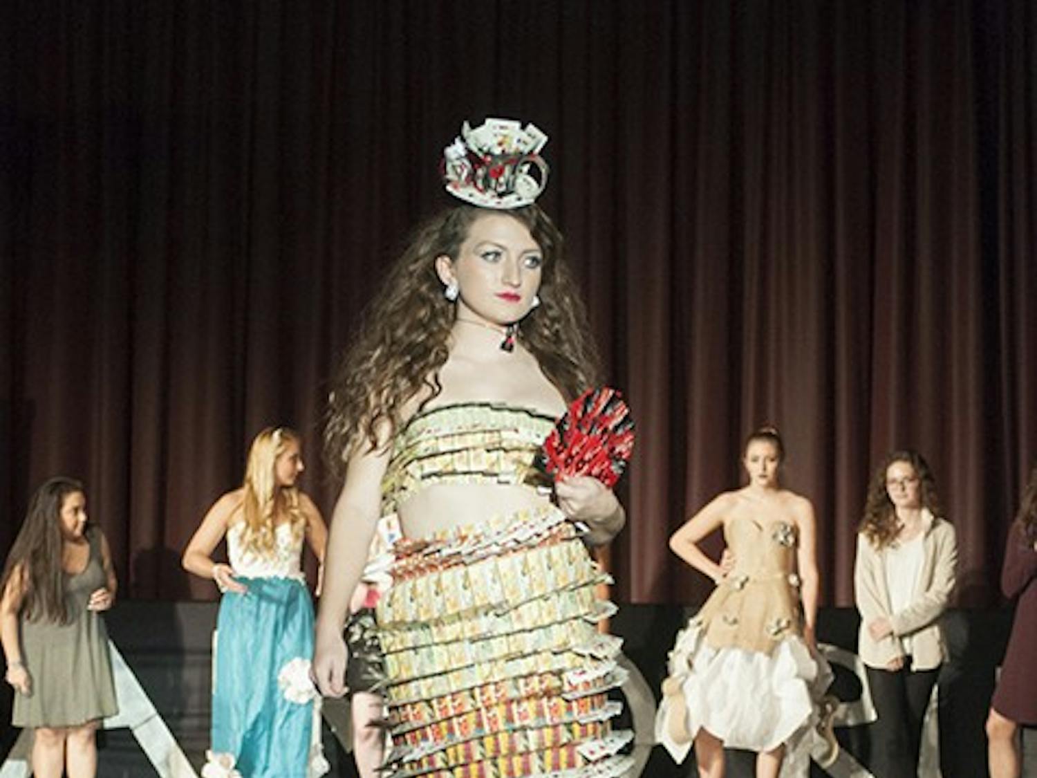 Third-year retail and fashion merchandising student Anne Coleman took home first place with her design made primarily from old playing cards. Her younger sister modeled the design for her.