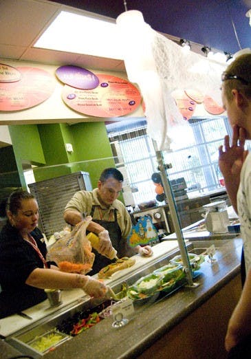 Angelina Barron and Derrick Johnson make Drew Davis a sandwich at Mondo Subs on Oct. 20. Chartwells manager Michelle Giles said the sandwich shop has the healthiest food options in the SUB. 