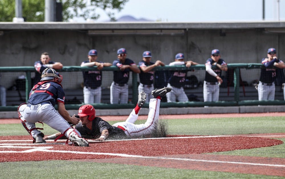 Philip Sikes slides to home base on the Lobos' second day against Fresno state on April 8, 2018 , The Lobos lost 7-6 against Fresno State.