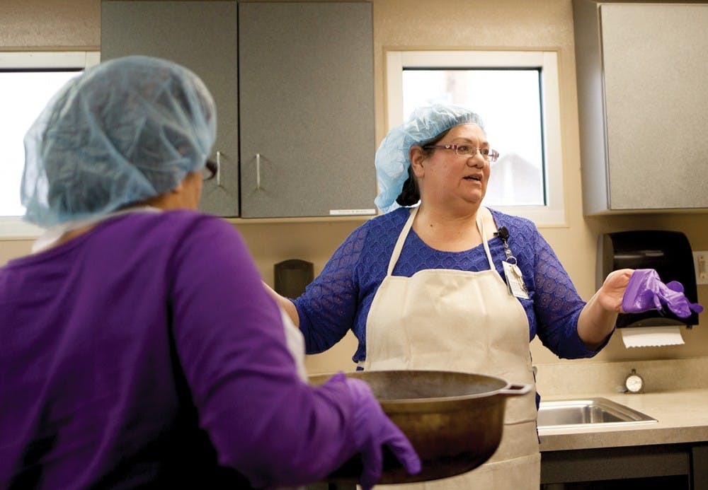 Participants at the UNM Psychiatric Center prepare for their cooking class. The UNM Health Sciences Center has catered this class to help participants recover from mental illness and substance abuse.