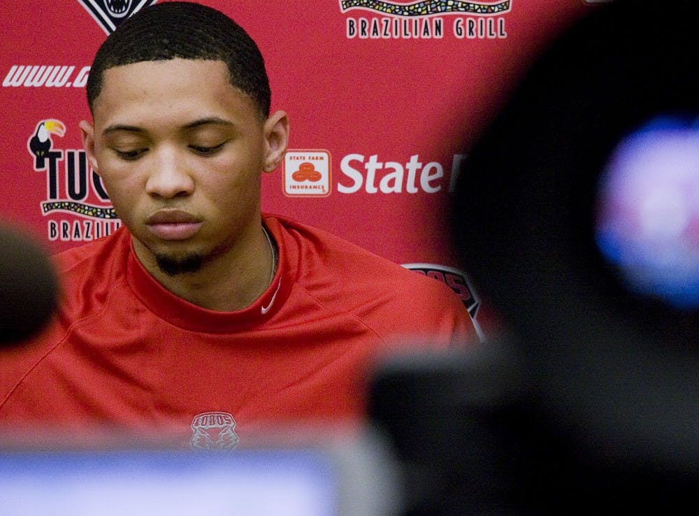 	Darington Hobson stares at the  oor during Tuesday’s news conference at the Davalos Center. Hobson announced he will forego his senior season in pursuit of his NBA dreams.
