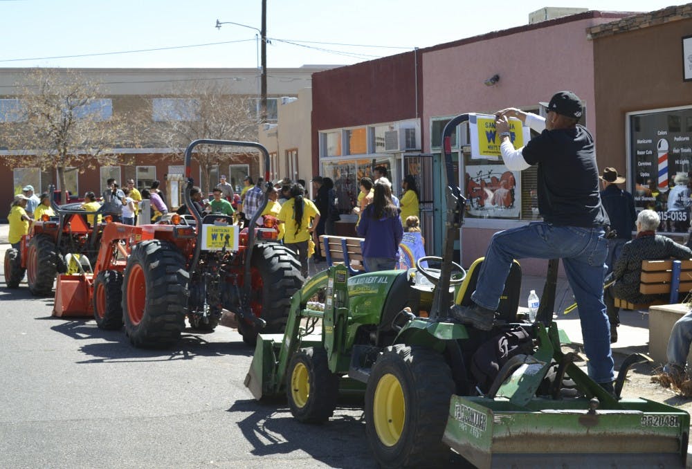 Citizens opposed to the Santalina development adorn tractors from South Valley farms with signs before joining a parade to the offices of the Bernalillo County Commission to protest the development.