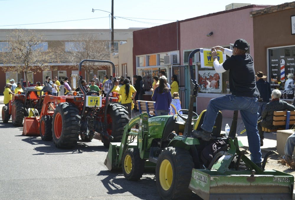 Citizens opposed to the Santalina development adorn tractors from South Valley farms with signs before joining a parade to the offices of the Bernalillo County Commission to protest the development.
