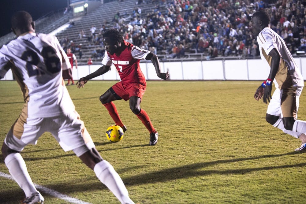 New Mexico forward James Rogers fends off Florida International University players during Saturday’s game. The No. 12 Lobos find themselves in Boca Raton, Florida, tonight to face Florida Atlantic before heading back on their home field on Sunday to battle Missouri State.