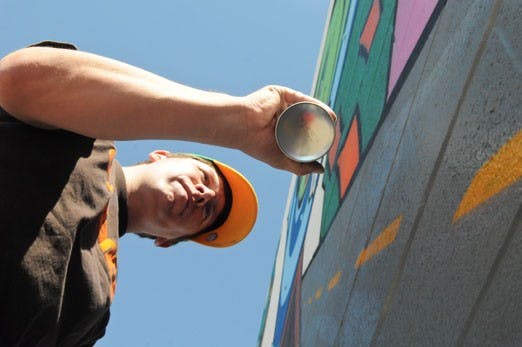 Joe Sullivan tags a wall Monday at Central Avenue and Morningside Drive. 