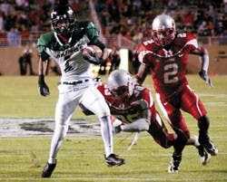 UNM's Major Mosley, center, and DeAndre Wright try to tackle Portland State's Tremayne Kirkland in the fourth quarter of Saturday's game at University Stadium. The Lobos lost 17-6.