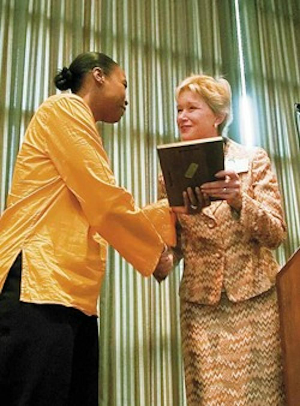 Andrea Mays, left, gets an award from Interim Dean Amy Wohlert for being one of the Outstanding Teaching Assistants of the Year during the Teaching Awards Ceremony in the SUB Ballroom on Wednesday.