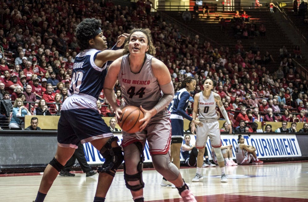 Jaisa Nunn drives to the basket past Gabby Ozoude of Rice during the first half of Tuesday's second round Women's National Invitational Tournament game in Dreamstyle Arena - The Pit. The Lobos won 93-73.