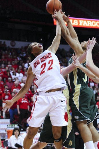 UNM's Georonika Jackson and CSU's Juanise Cornell battle for the ball in Wednesday's quarterfinal game of the Mountain West Conference Tournament. The Lobos surged past the Rams in the closing minutes on the way to a 62-48 victory. UNM will face No. 1 Uta