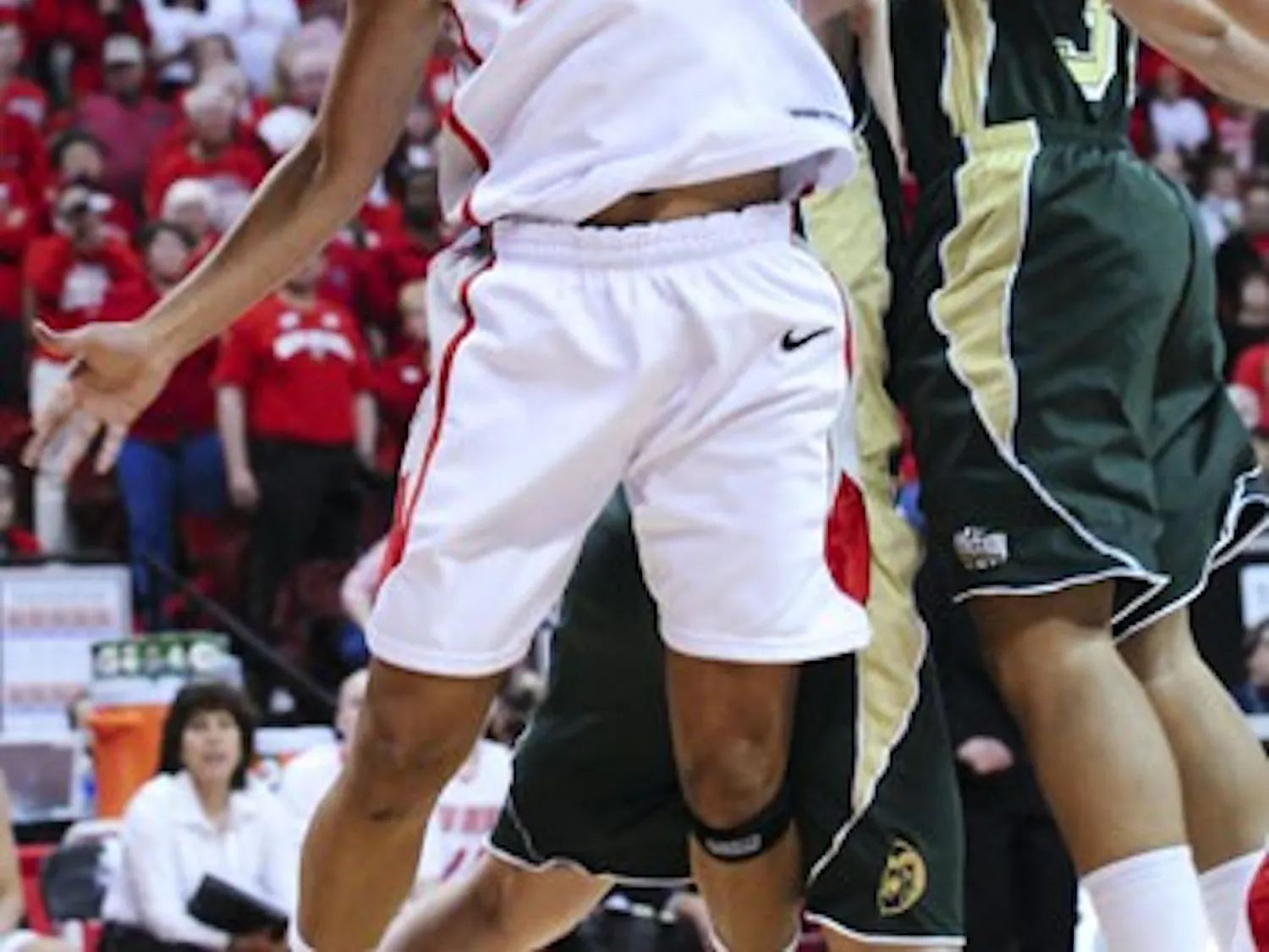 UNM's Georonika Jackson and CSU's Juanise Cornell battle for the ball in Wednesday's quarterfinal game of the Mountain West Conference Tournament. The Lobos surged past the Rams in the closing minutes on the way to a 62-48 victory. UNM will face No. 1 Uta