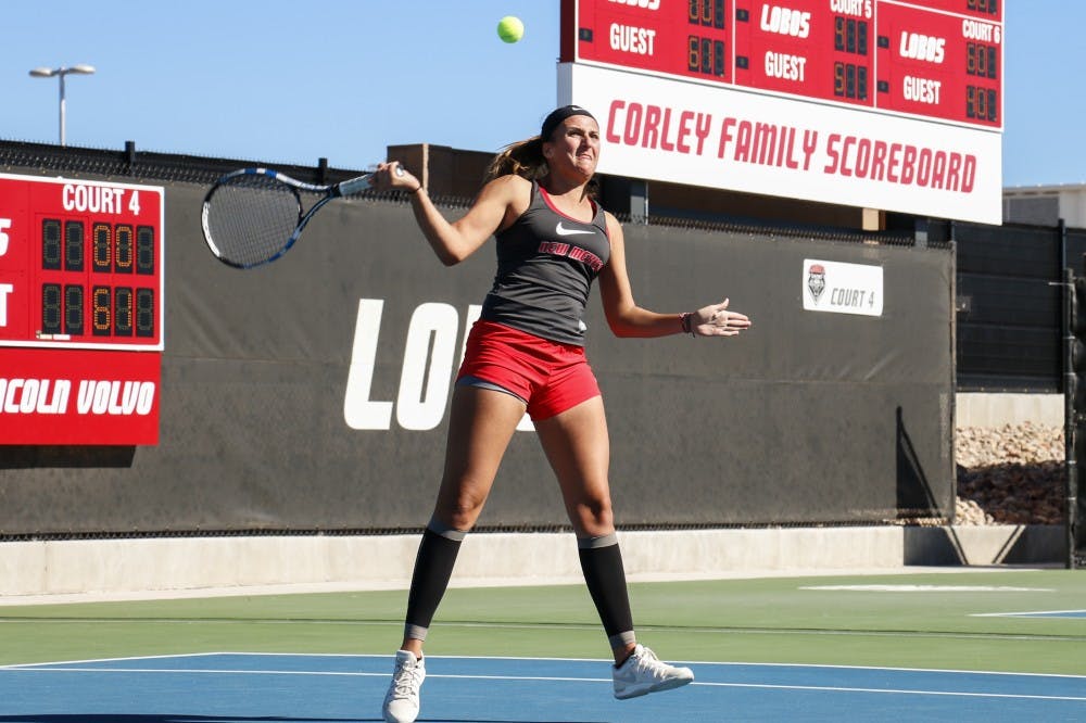 Junior Ludivine Burguiere arches back to return the ball Nov. 1, 2015 at the McKinnon Family Tennis Center. The Lobos beat Colorado Friday 5-2 and will play Southern Illinois on Saturday.