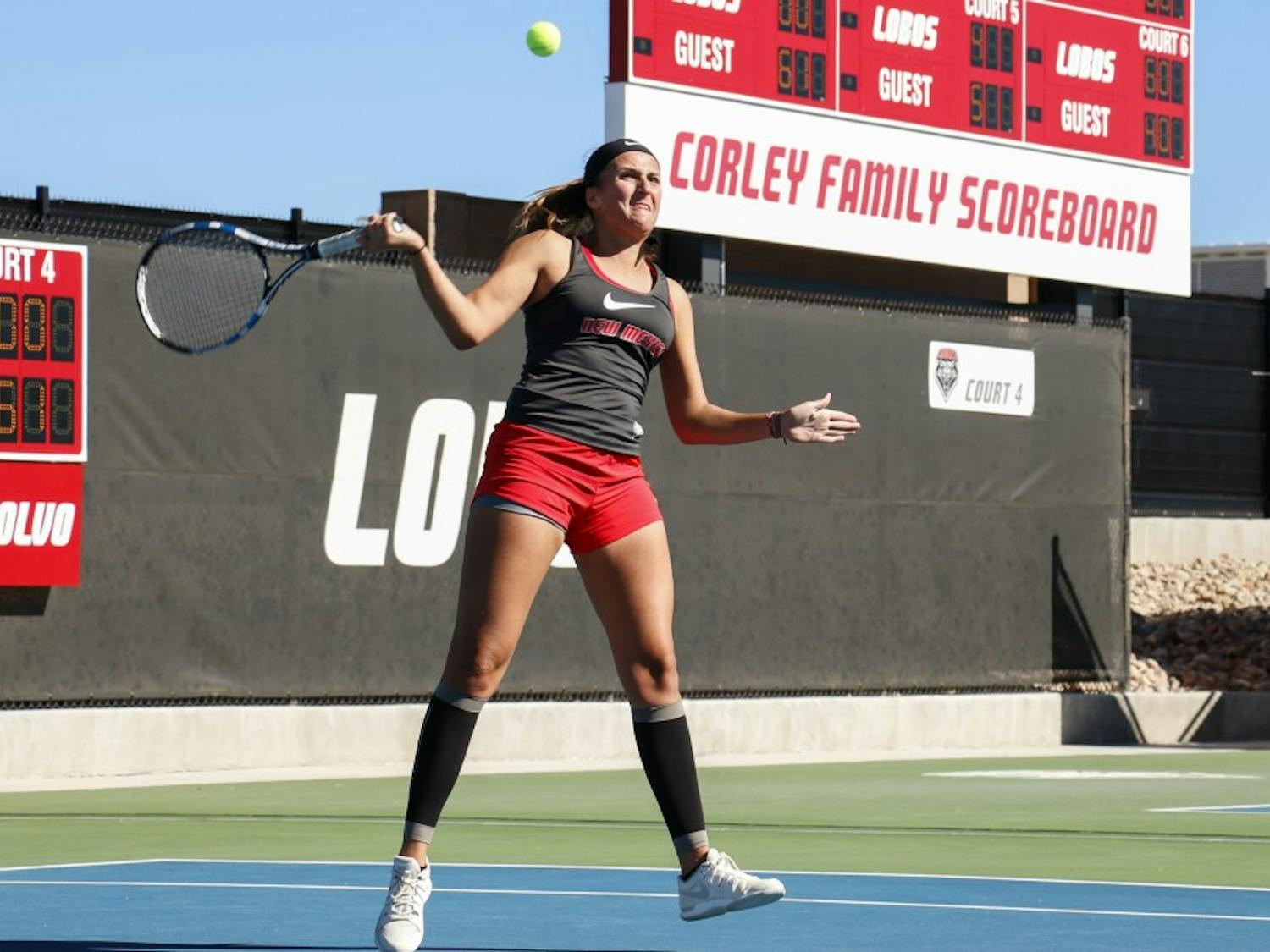 Junior Ludivine Burguiere arches back to return the ball Nov. 1, 2015 at the McKinnon Family Tennis Center. The Lobos beat Colorado Friday 5-2 and will play Southern Illinois on Saturday.