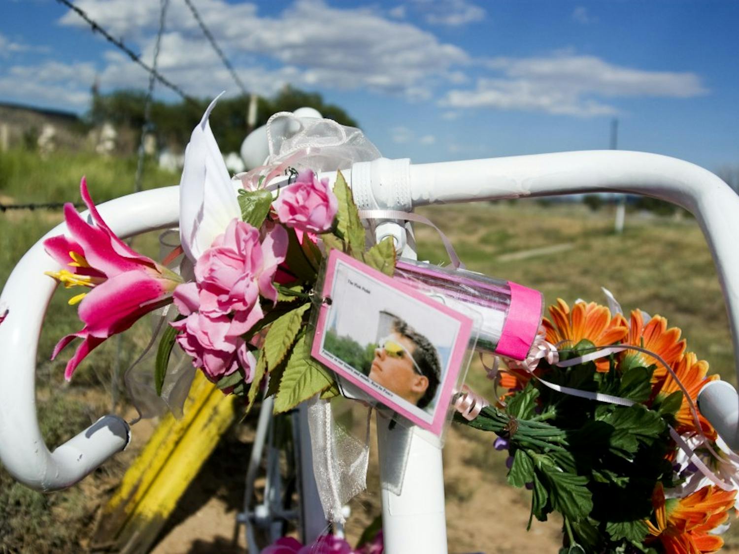 A memorial in honor of cyclist John Anczarski is mounted beside State highway 124 near the Laguna Pueblo. The 19-year-old cyclist was killed while riding his bike across the country to promote breast cancer awareness.