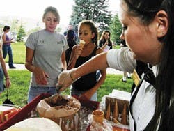 Liana Veltman, right, scoops ice cream for freshman Kirstyn Rechner, left, during the third Freshman Family Day at the Duck Pond on Sunday.