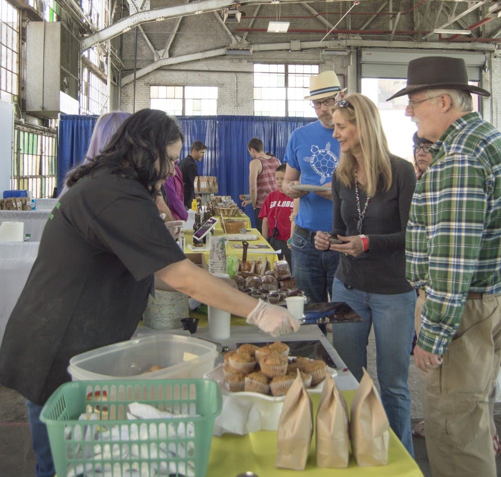 Annapurna employes give out samples of their gluten-free vegetarian muffins at the Naked Food Festival on Saturday. The fair was a market where people brought locally grown, organic food for sampling and purchase.  
