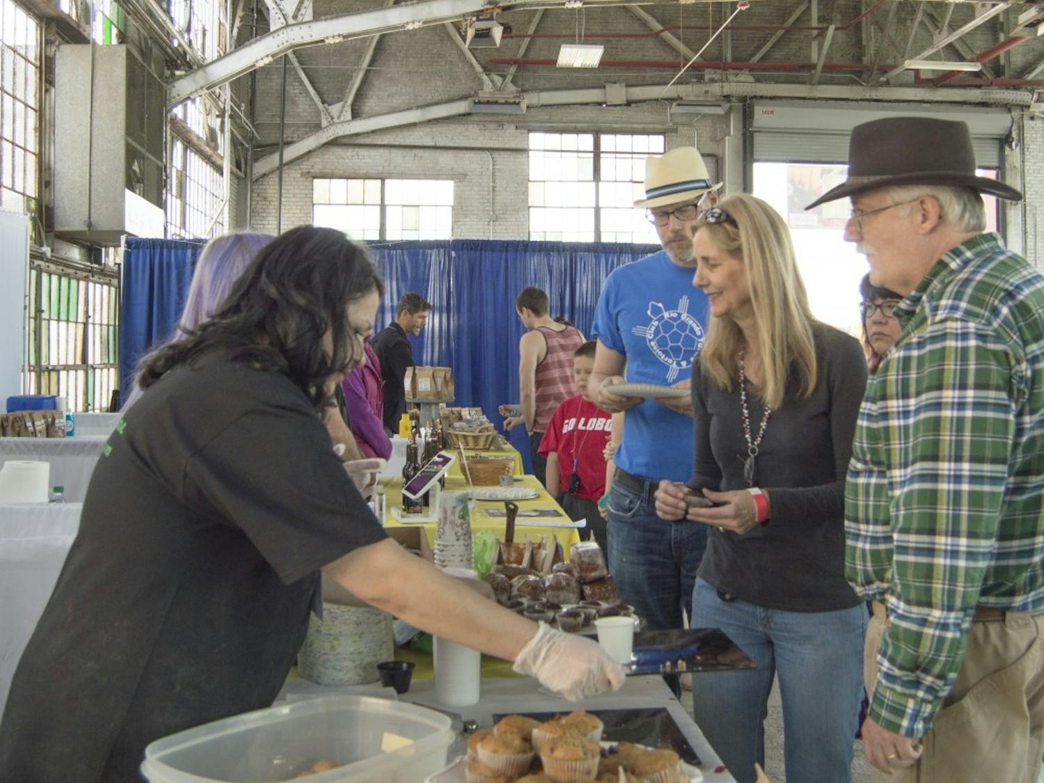 Annapurna employes give out samples of their gluten-free vegetarian muffins at the Naked Food Festival on Saturday. The fair was a market where people brought locally grown, organic food for sampling and purchase.  