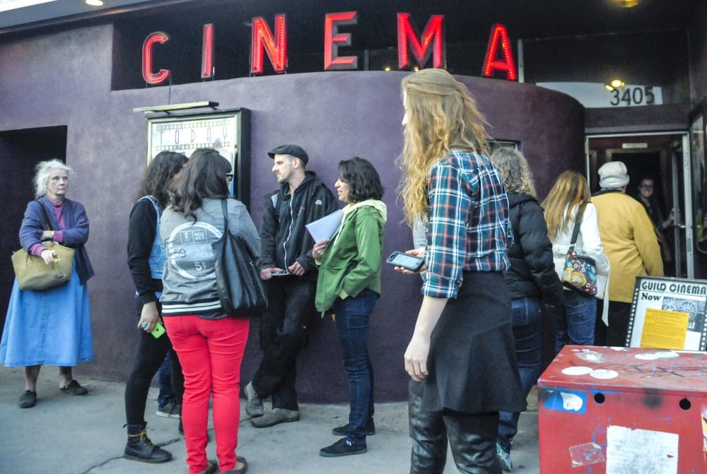 A group of people wait in front of the Guild Cinema to view series of films shown during the Sin Fronteras film festival Saturday. The films focused on social issues as well as artistic qualities in Latin America. 