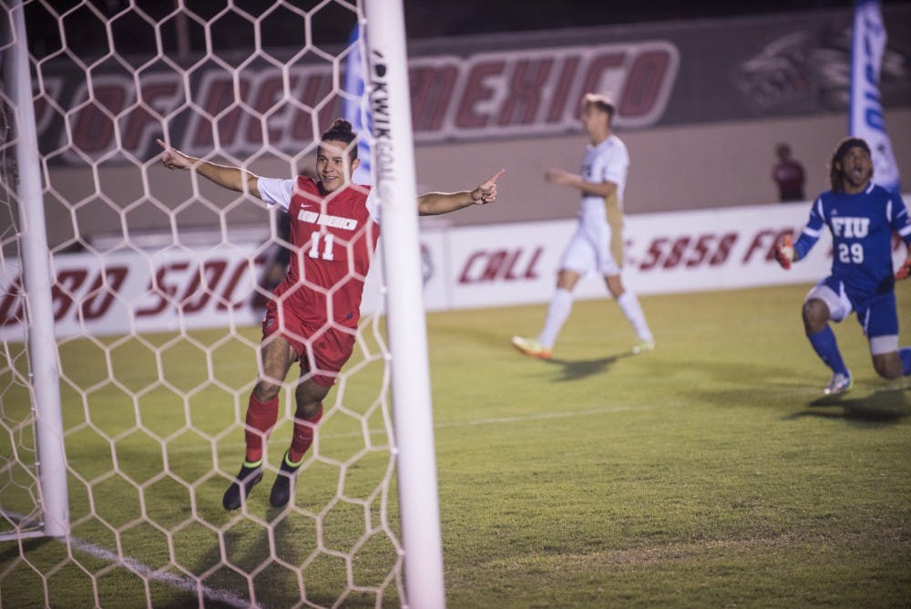 Lobos forward Niko Hansen flies by Florida International’s goalie after his shot hits its mark during their Oct. 4, 2014 game. The Lobos kick off a home tournament against San Diego this Friday at 7 p.m.