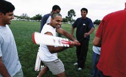 Anand Ganti jokingly paddles a teammate after practice with a new cricket bat Wednesday at Johnson Field. The UNM Cricket Club recently joined the Colorado Cricket League, which has teams from Denver, Colorado Springs, Coal Creek, Littleton and Fort Colli