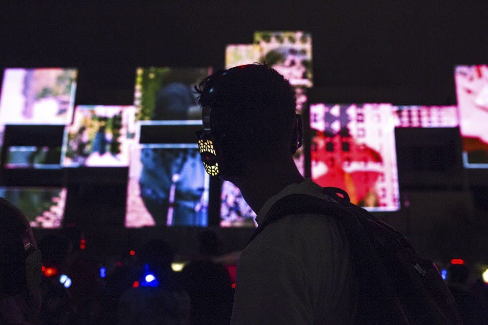 A student looks out over dancers during the 2016 Silent Lights in Smith Plaza.
