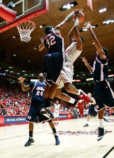 UNM's A.J. Hardeman gets blocked by Ole Miss' Zach Graham. The Lobos eased past the Rebels 103-70. 