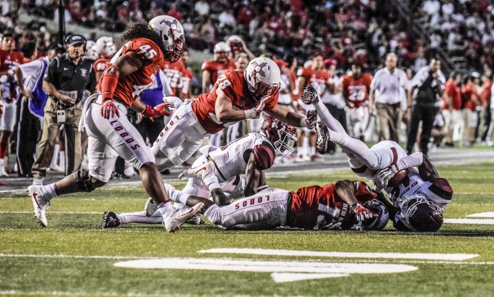 Jaleel Scott of the Aggies recovers a loose ball contested by Jalin Burrell of the Lobos during the UNM vs. NMSU game at Dreamstyle Stadium on Sept. 9, 2017.
