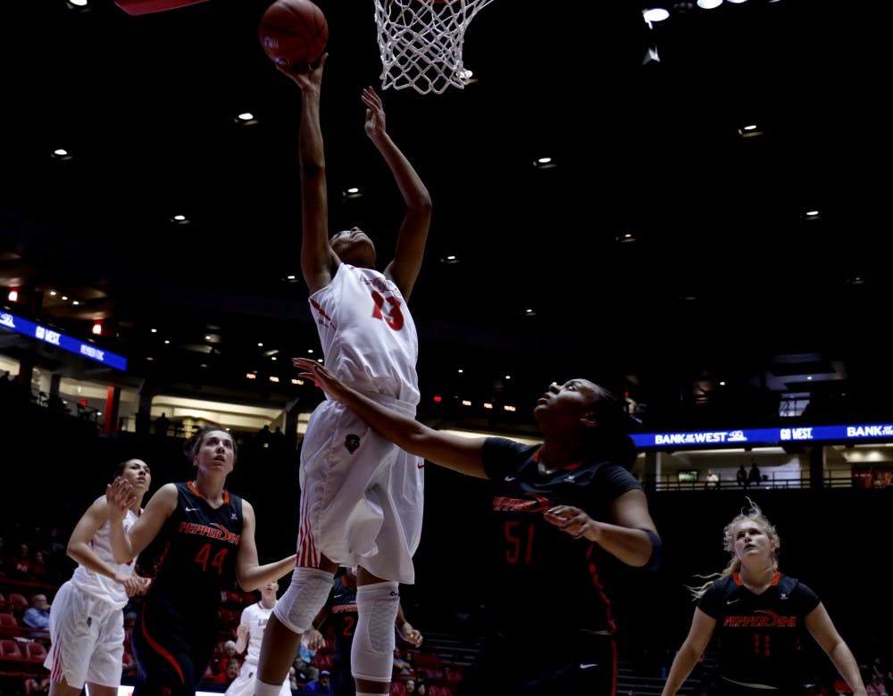 Senior forward Khadijah Shumpert leaps for a lay up at WisePies Arena Saturday afternoon. The Lobos beat Pepperdine 60-52.