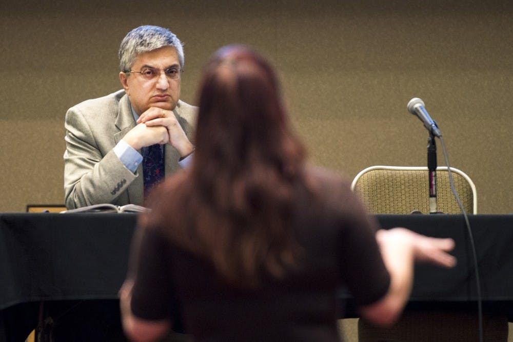 Provost Chaouki Abdallah listens to Sarah Nezzer as she asks questions during a conference held Wednesday afternoon at the SUB. The provost and President Bob Frank spoke to community members about the University's budget.