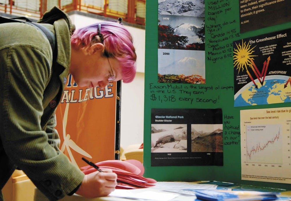 Student Amanda Mione signs a valentine Tuesday in the SUB that will be sent to Gov. Bill Richardson. The student chapter of NMPIRG asked people to make cards to encourage Richardson to sign legislation mandating that all public buildings get 30 percent of