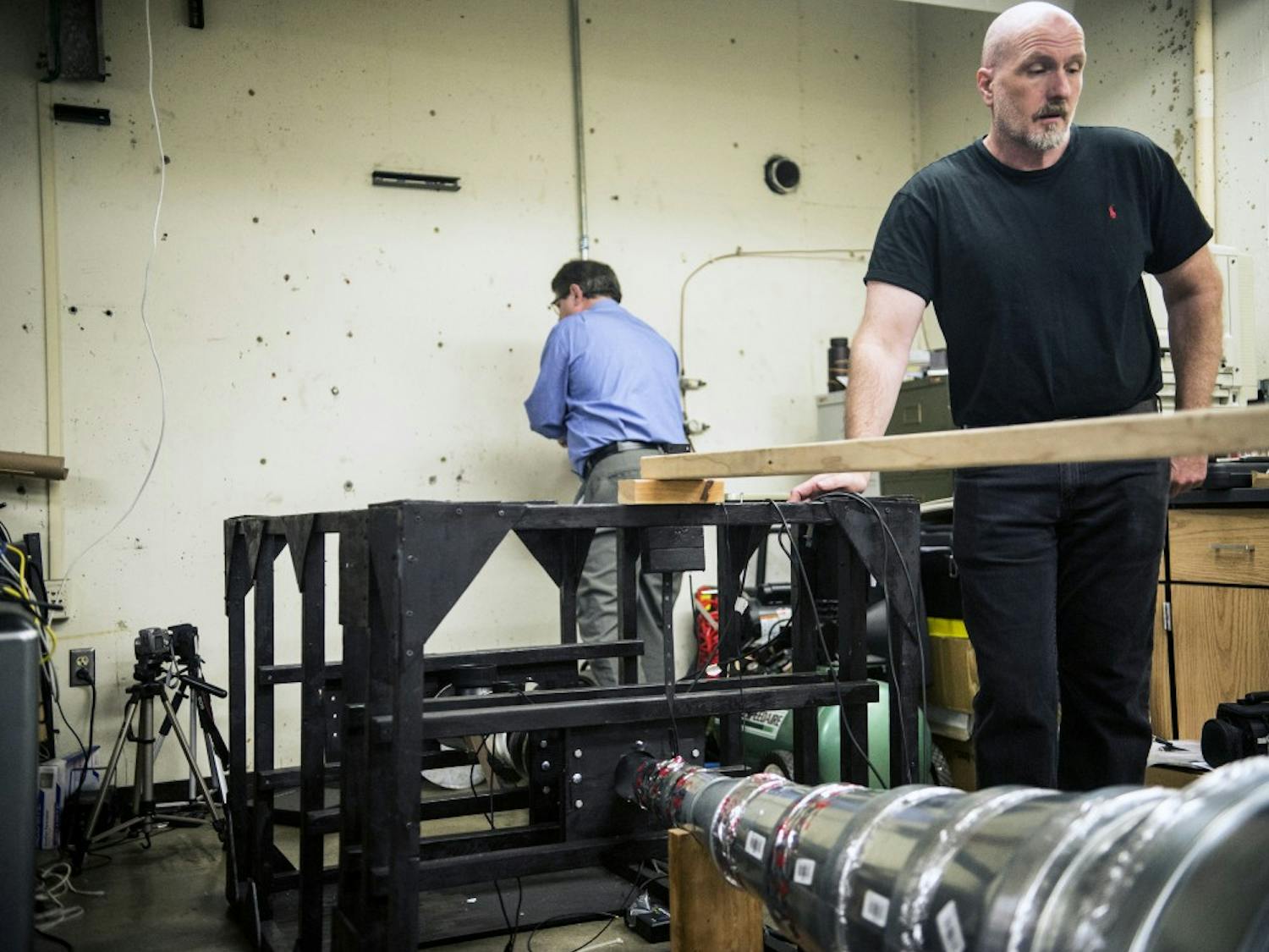 Peter Vorobieff (right) and Craig Davidson set up their hybrid propulsion test rig at the Mechanical Engineering Building Tuesday, Oct. 27, 2015. Vorobieff and Davidson are using a series of magnets that aid the process of charging ions to create an efficient source of propulsion. 