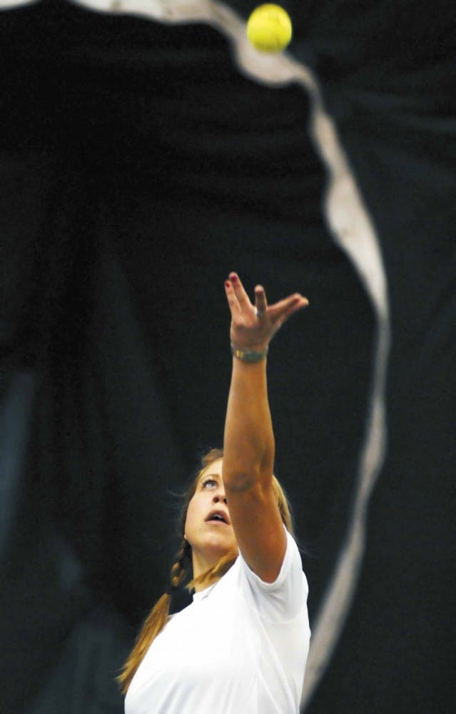 UNM tennis player Jennifer Ryba serves during a doubles match against Northern Arizona on Saturday at the UNM Tennis Complex.
