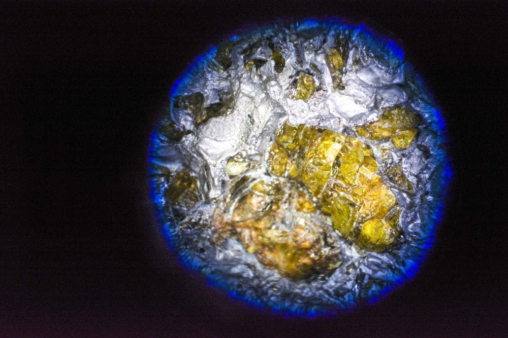 A piece of pallasite meteorite is seen under a binocular microscope at Northrop Hall on Tuesday. Meteorites can be analyzed at the Center for Stable Isotopes, a new research facility soon to open its doors at UNM.