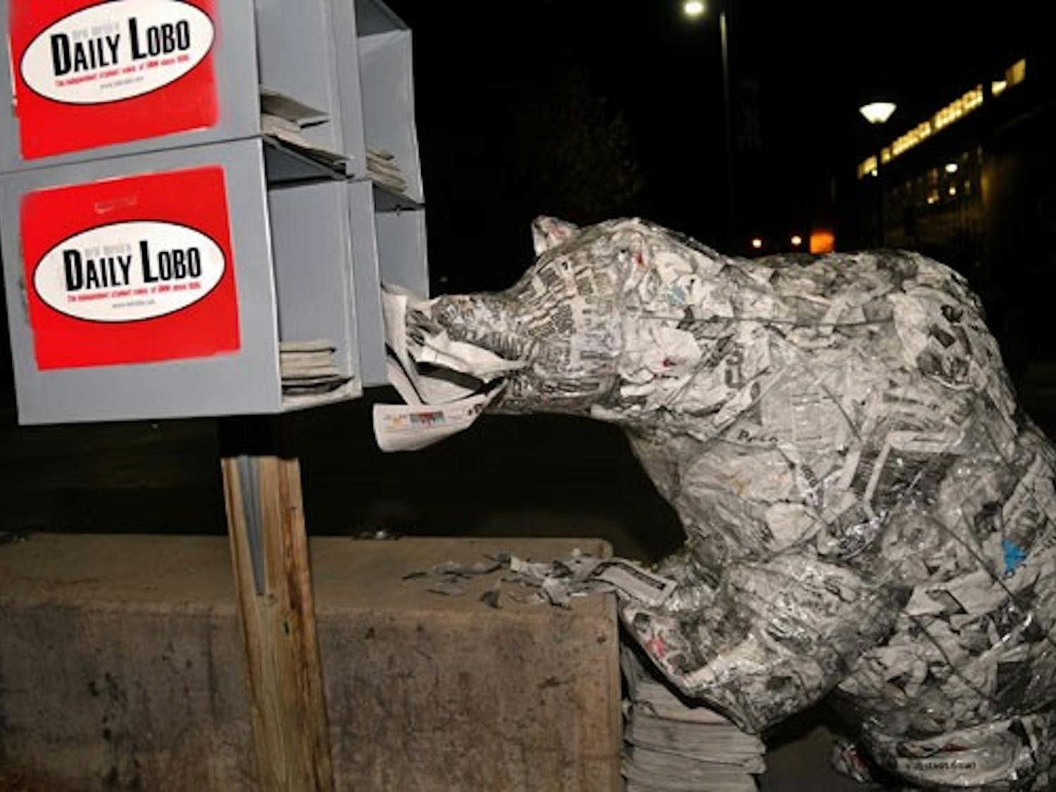 A bear, sculptured out of copies of the Daily Lobo, munches on newspapers outside the Bookstore on Wednesday. The sculpture had no label indicating artist or title.   