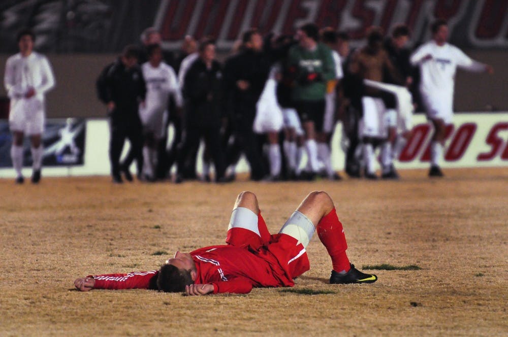 	Forward Justin Davis lies motionless on the field after the Lobos were downed 2-1 by Portland in overtime at the UNM Soccer Complex. Thursday’s game was the seniors’ last one in a UNM uniform.