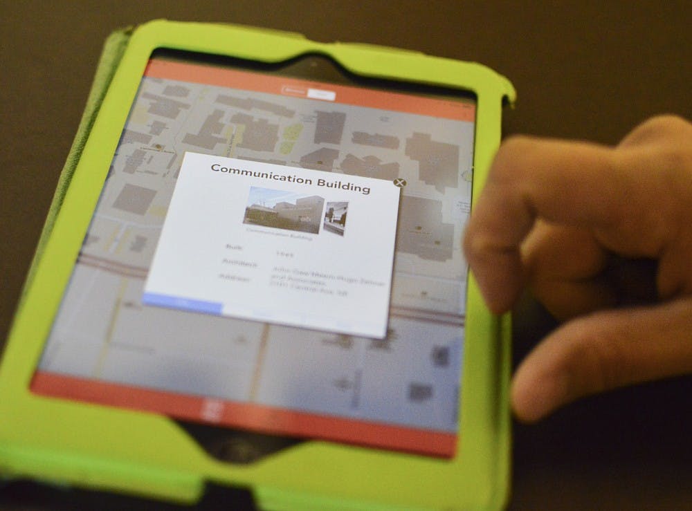 	Torran Kahleck, the UNM student who designed UNM Pocket Archivist, demonstrates how the new app works Friday morning. The new app can be downloaded for free on iTunes.