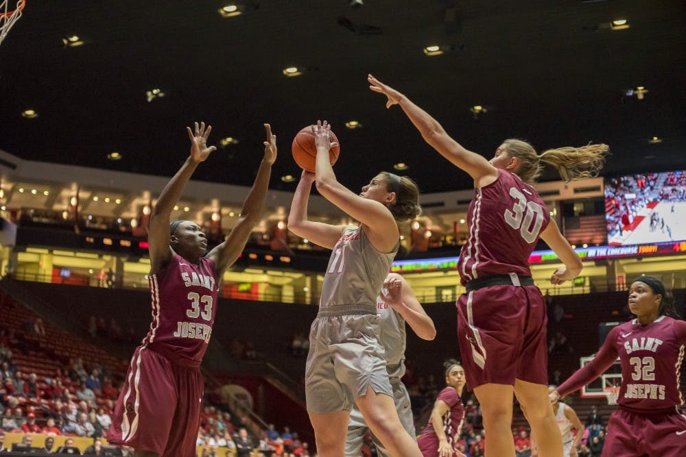 Emily Lines (11) attempts a shot against Joseph's tough defense on Saturday November 26th at WisePies Arena