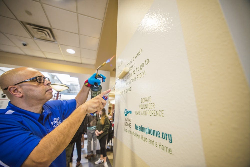 King of Wrap Owner&nbsp;Raul Rodriguez installs a mission statement at the SUB on Thursday Jan. 19, 2016.&nbsp;