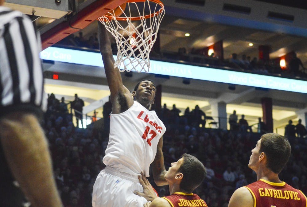 Lobo redshirt sophomore guard/forward Devon Williams, 12, makes a slam dunk during the game against USC on Sunday afternoon. The Lobos will host New Mexico State tonight at 7 p.m.