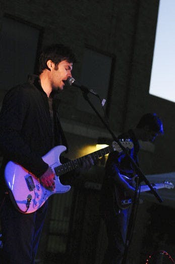 Youth Pastor Chuck Elmore plays with his band at an event for the Free Stuff Guys on Thursday at Albuquerque's First Baptist Church at 101 Broadway Blvd.