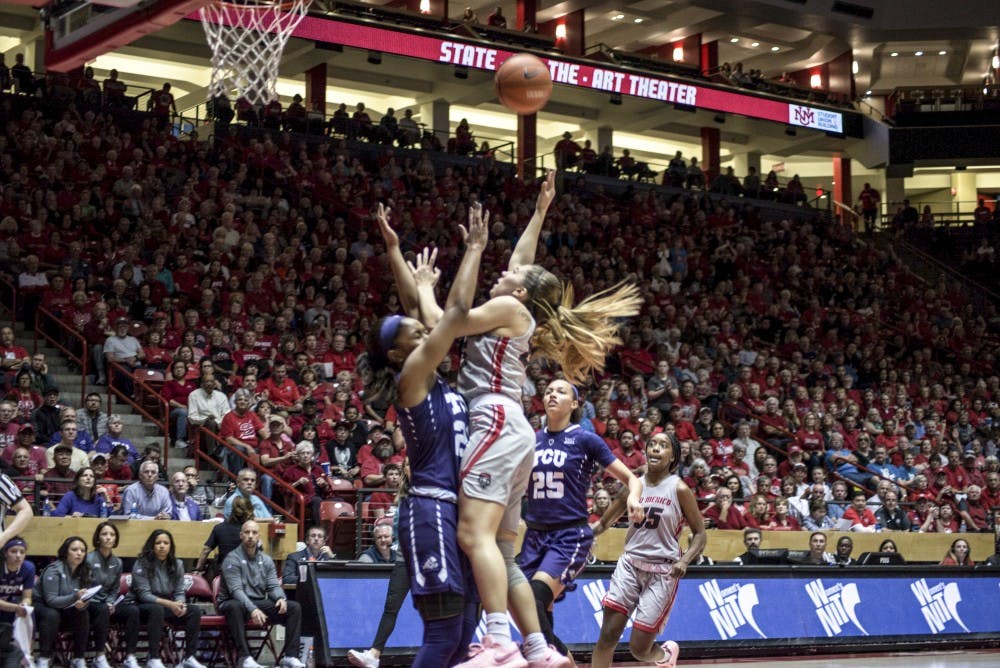 Laneah Bryan shoots over Lauren Heard during the first half of Thursday night's third round WNIT game at Dreamstyle Arena-The Pit. TCU defeated the Lobos 81-72.