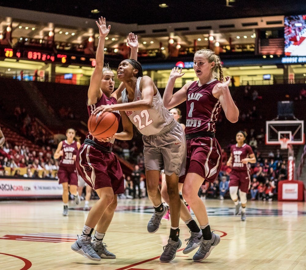 Freshman guard Mykiel&nbsp;Burleson breaks past two St. Joseph's players during their match Saturday, Nov. 26, 2016 at WisePies Arena. The Lobos will face off against NMSU this Wednesday in Las Cruces, New Mexico.&nbsp;